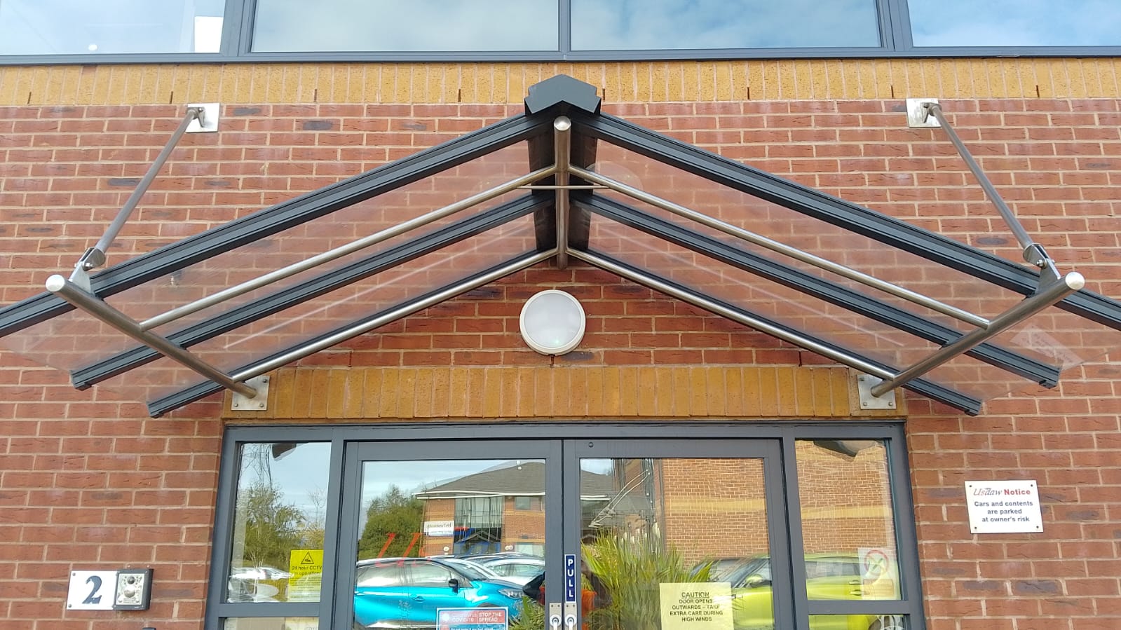 Glass shelter above building entrance